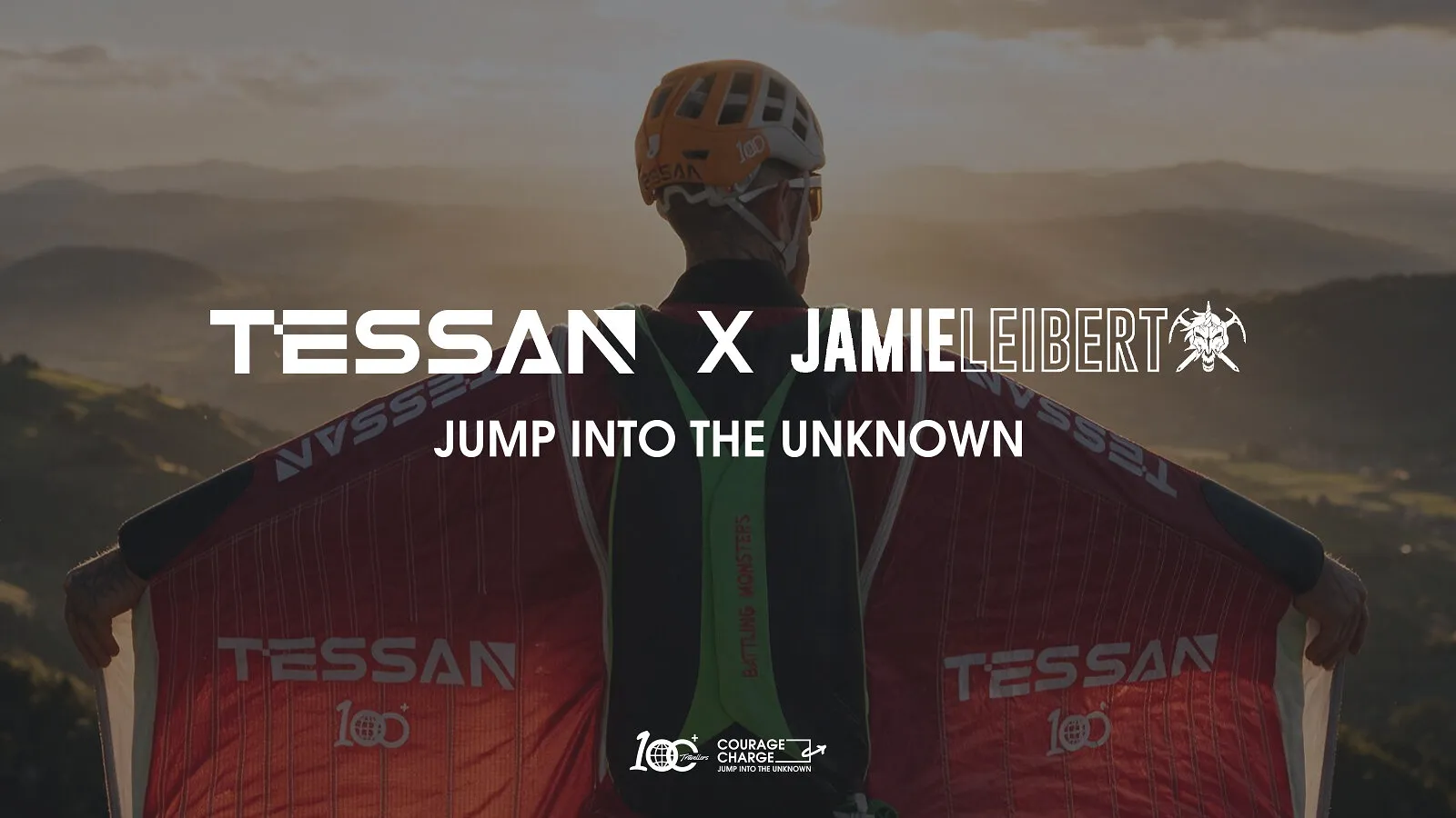 A helmeted wingsuit athlete overlooks misty mountains with Tessan x Jamie Leibert text.
