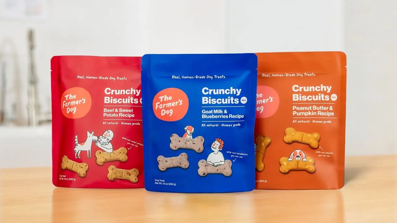 Three bags of The Farmer’s Dog Crunchy Biscuits in beef, goat milk and blueberry, and peanut butter flavors.