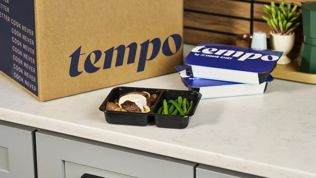 Tempo meal boxes and a prepared meal tray on a kitchen counter.