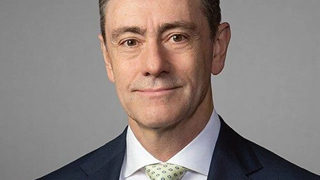 Marcello Boldrini, CEO of SI Group, in a suit and patterned tie against a gray background.