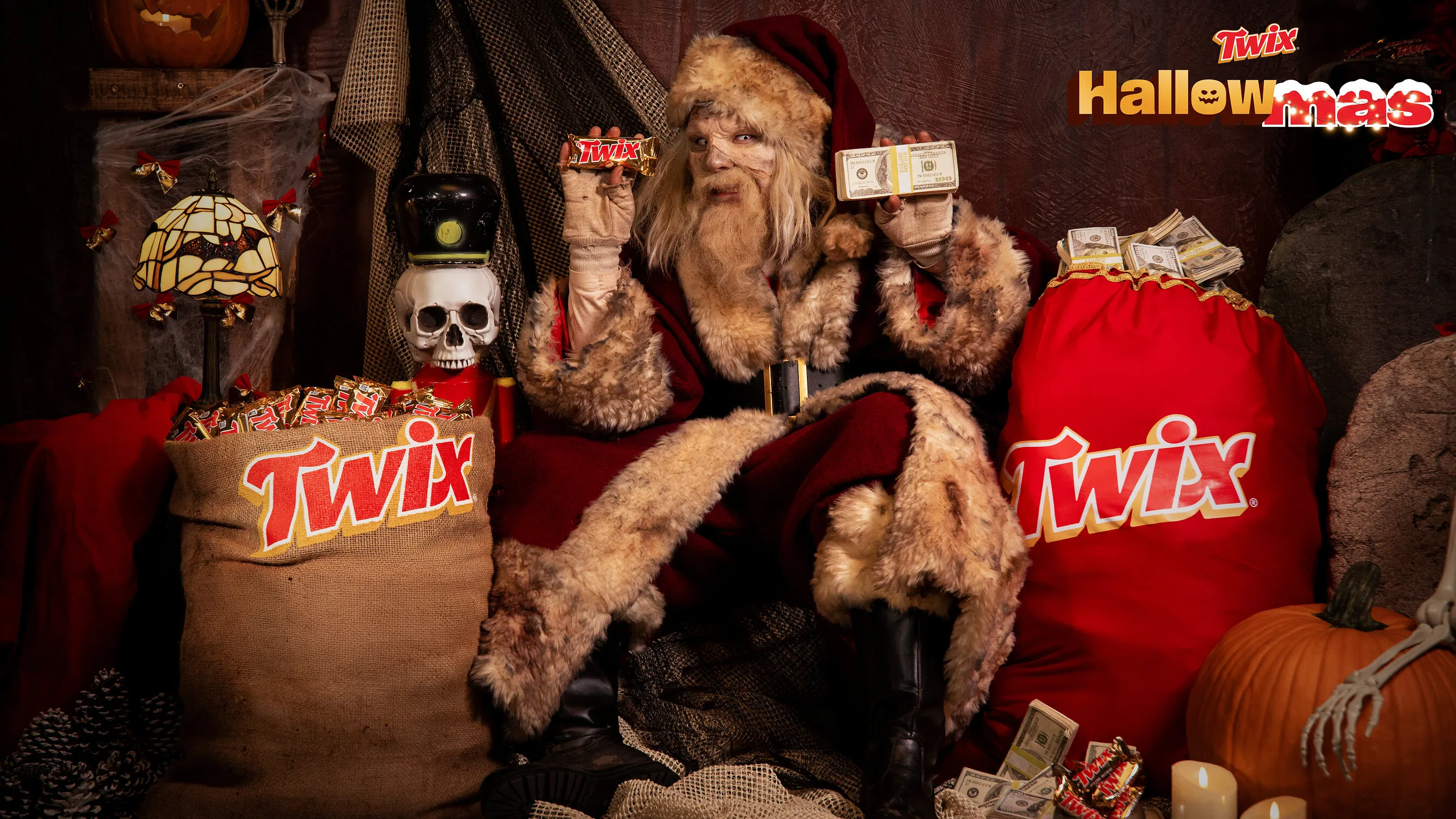 A Santa-like figure holds Twix bars and cash beside Halloween decorations and Twix sacks.