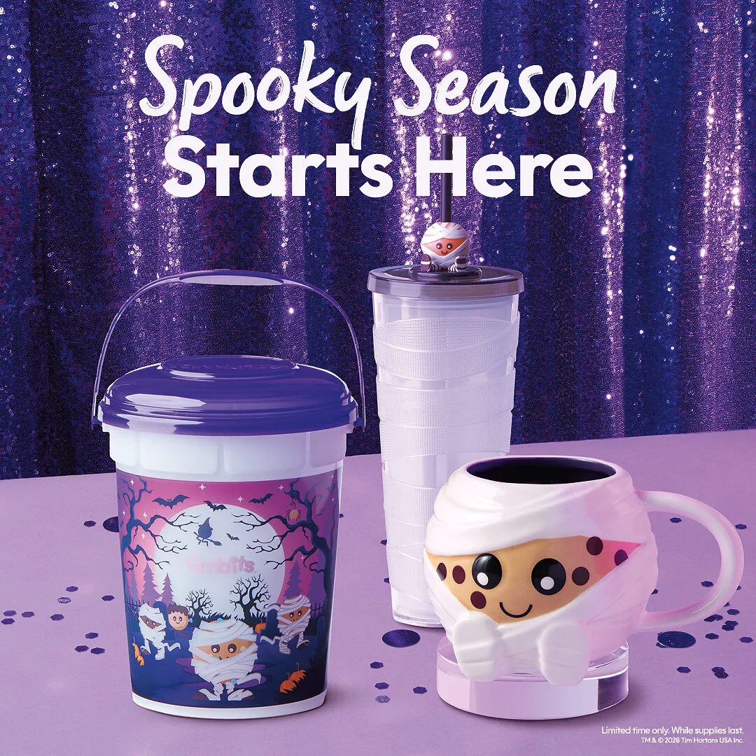 Halloween-themed Tim Hortons cups and a mummy mug against a purple glittery backdrop.