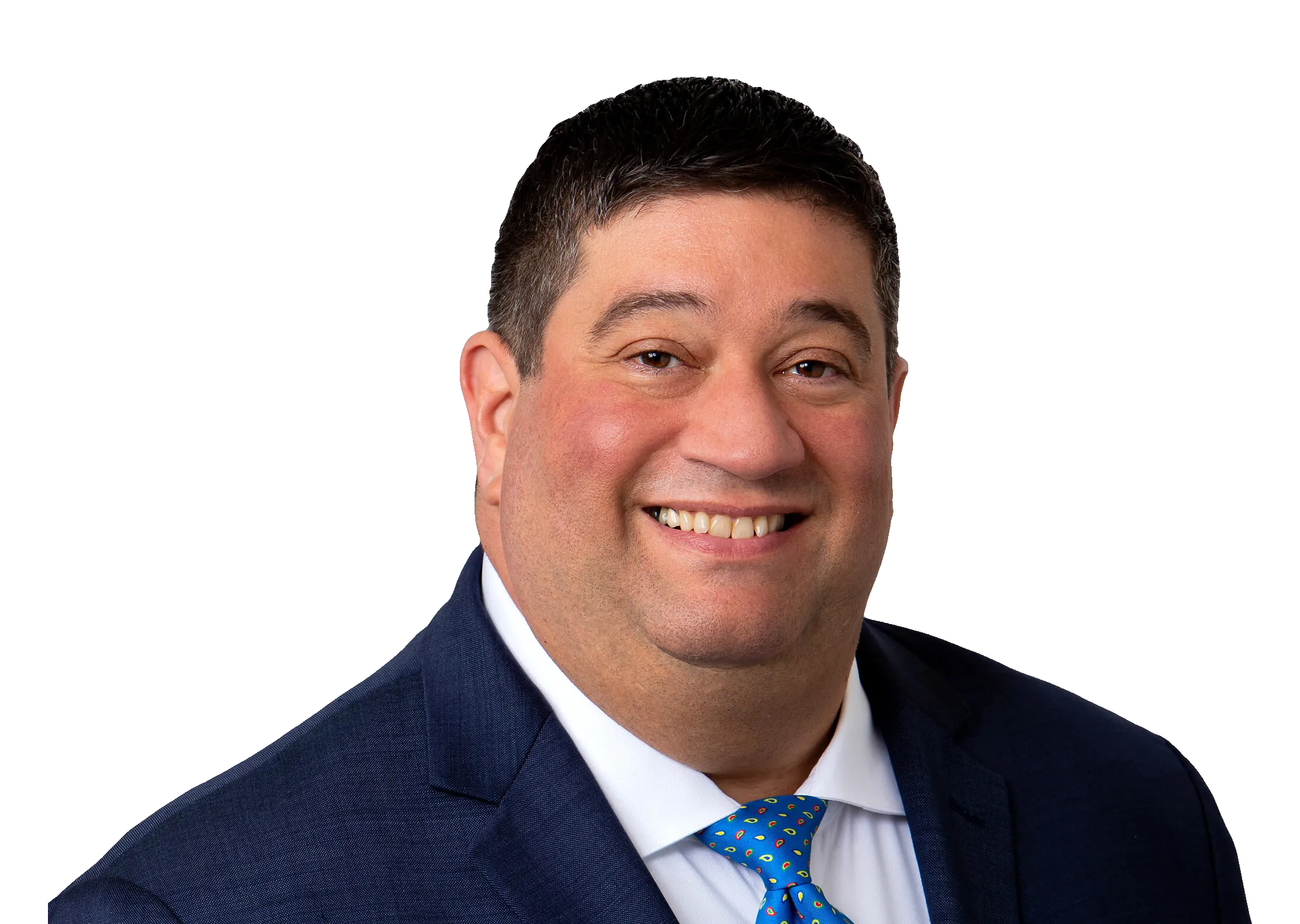 Brian Botkin in a navy suit and patterned blue tie against a gray background.