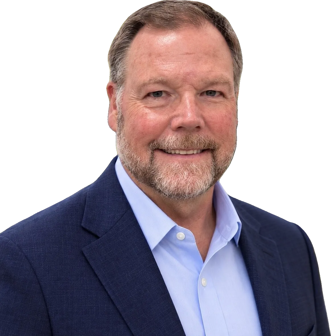 Smiling bearded man in a navy blazer and light blue shirt outdoors