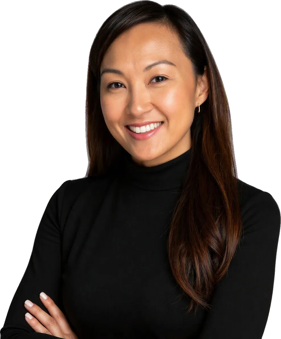 Angelica Munson smiling in a black turtleneck against a gray background.