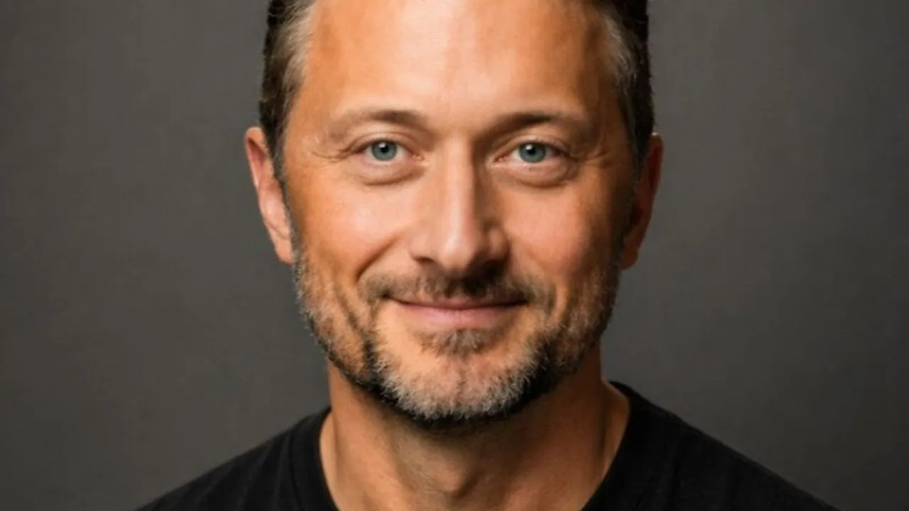 Steve Elliott, CEO of Dotwork, smiling against a dark background.