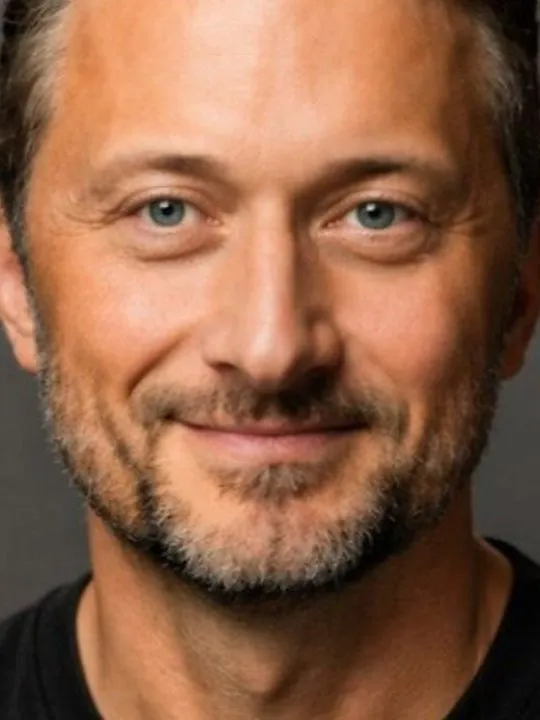 Steve Elliott, CEO of Dotwork, smiling against a dark background.