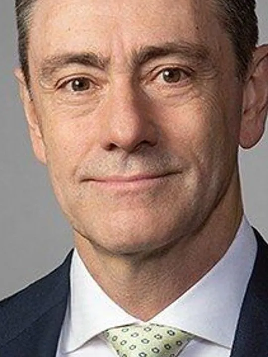Marcello Boldrini, CEO of SI Group, in a suit and patterned tie against a gray background.